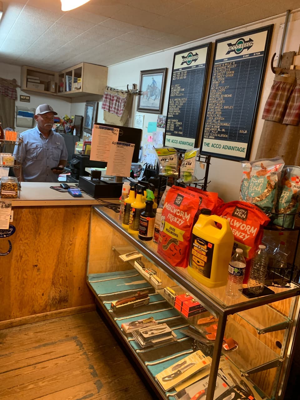 A Mustang Creek Feed Seed & Supply team member helping a customer at the front counter in Rio Vista, Texas